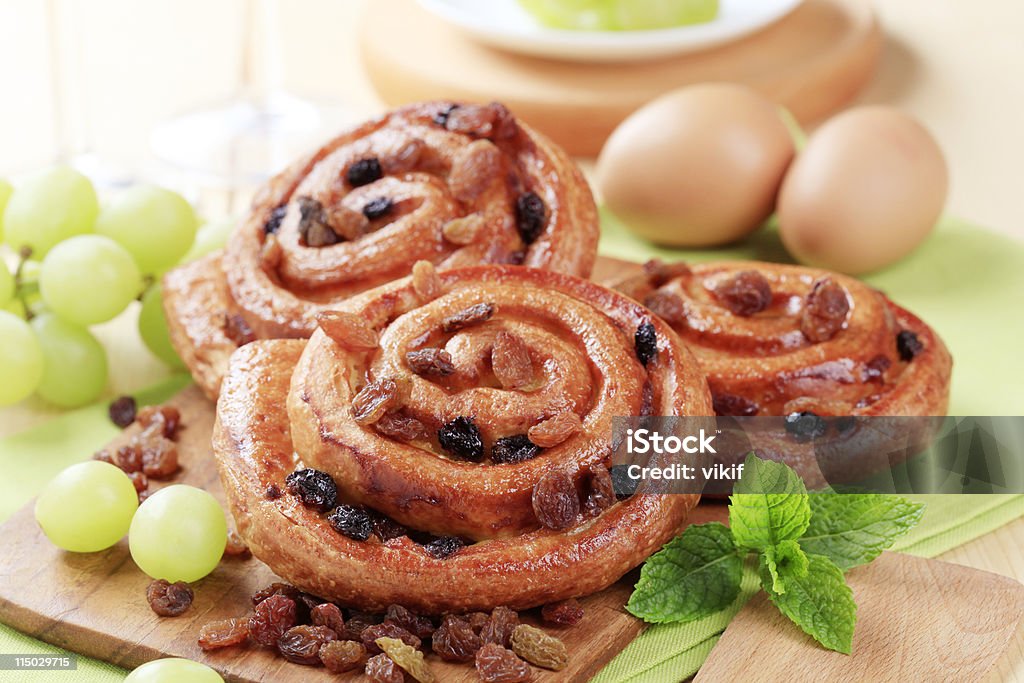 Danish pastry Sweet pastry rolls with raisins on a cutting board Bread Stock Photo