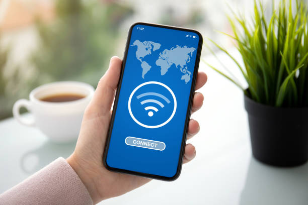 istock female hand holding phone with app wifi connect on screen 1150297591