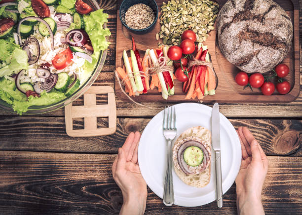 istock lunch at the table with different food, women's hands with a plate 1150299661