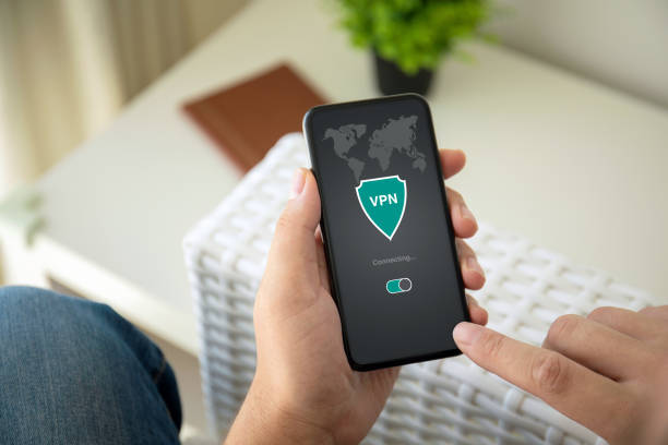 istock man hands holding phone with app vpn private network in the room 1150299916