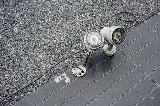 LED spot lights install on black wooden ground floor.
