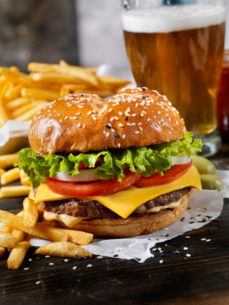 istock Classic Cheeseburger on a Brioche Bun with Fries and a Beer 1150301353