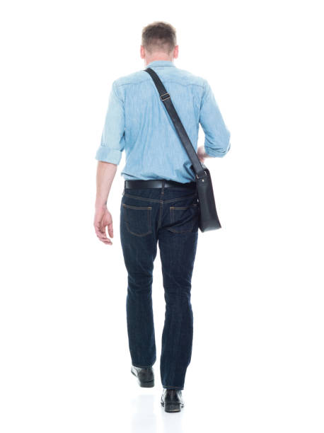 istock Rear view of man walking with a shoulder bag 1150304374