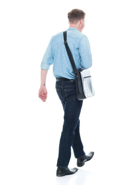 istock Rear view of man walking with a shoulder bag 1150304384