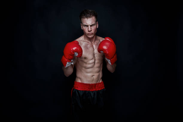 istock Sexy male boxer on black background 1150304777