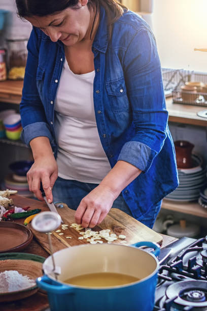istock Cutting Fresh Garlic on Wooden Cutting Board 1150305087