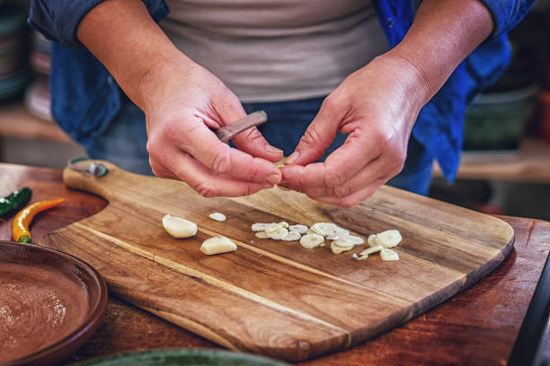 Cutting Fresh Garlic on Wooden Cutting Board