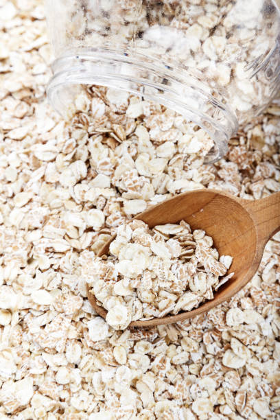 istock raw oatmeal with a spoon on the table 1150305142