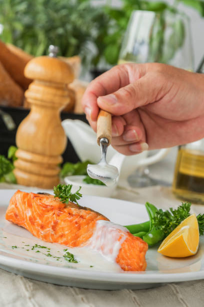 istock Salmon fish fillet grilled steakand vegetable on plate. 1150311004