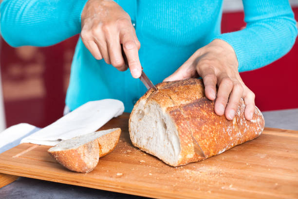istock woman cutting some bread 1150311268