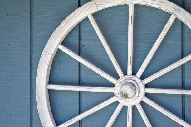 istock Old white wood wagon wheel decor 1150311790