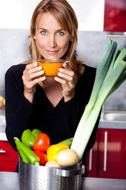 woman eating vegetable soup