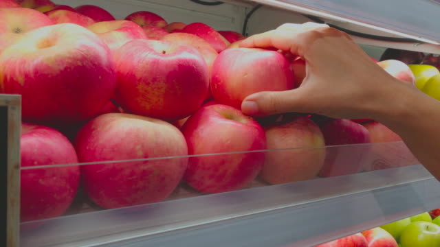 Woman Choose Apple In Supermarket Shot By Smart Phone