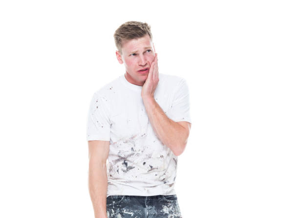 istock Young attractive male painter standing on white background - sadness 1150315735