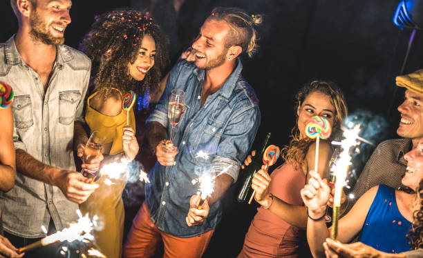 multiracial friends having drunk fun at summer festival celebration - young people drinking and dancing at after party in night club - friendship concept on excited mood - focus on blue jeans man face - celebration drunk drinking after party imagens e fotografias de stock