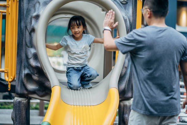istock Father and daughter playing in park 1150318375