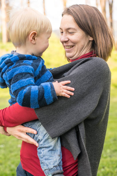 istock Happy Mother Holding Her Son at a Picnic in Springtime 1150324013