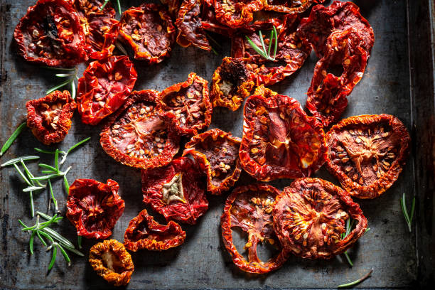 istock Closeup of tomatoes dried on baking tray 1150324356