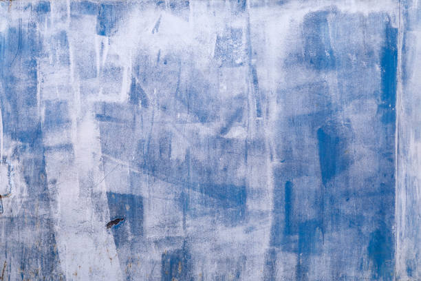 istock unevenly painted blue metal surface,shot on a Sunny spring day 1150325651