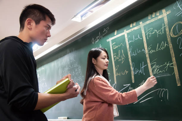 istock Students trying to solve an exam question on chalk board in classroom 1150326094
