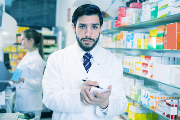 istock guy pharmacist is inventorying medicines 1150331787