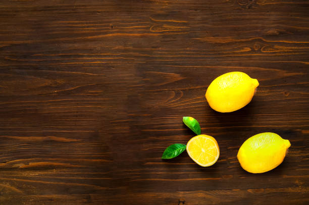 istock Lemons on dark wooden table.  Top view,copy space, closeup. 1150334523