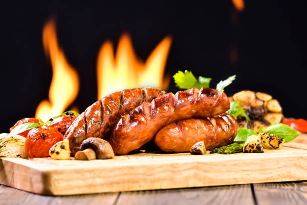 istock Grilled sausages and various vegetables on chopping wood 1150334748
