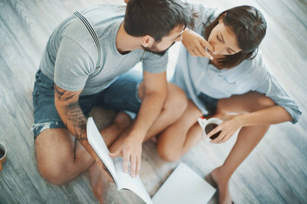 Young couple looking at decoration brochures.