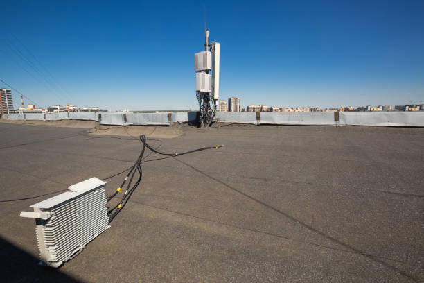istock Working process of upgrading telecommunication equipment. Dismantled old generation outdoor radio units and coaxial cables are on the roof during  process of modernisation  communication equipment of basic station of GSM  DCS UMTS LTE bands. 1150337359