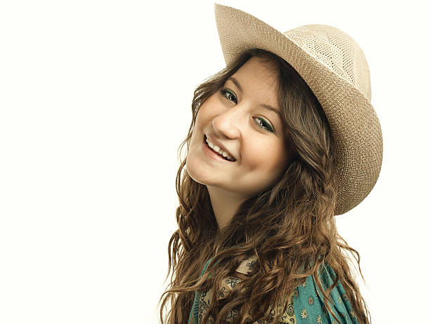 Teenager girl looking at the camera posing.Portrait of a lovely young cowgirl.