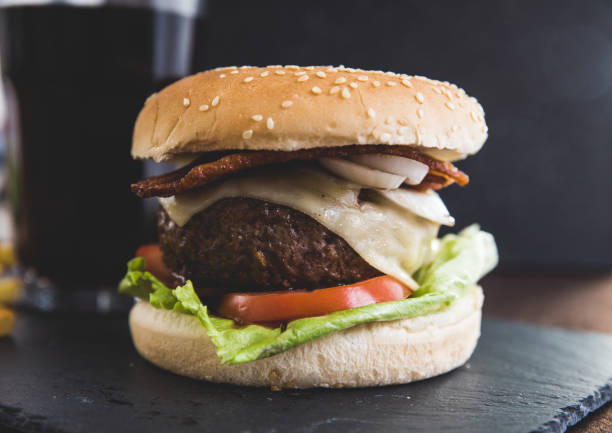 istock Delicious burgers with beef patty, bacon, cheese and cabbage 1150339543