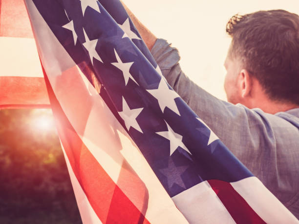 istock Handsome, young man waving an American flag 1150340918