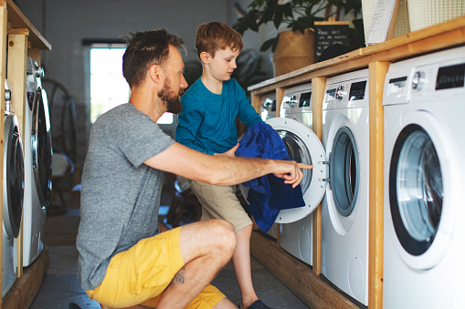 Father and son in laundry