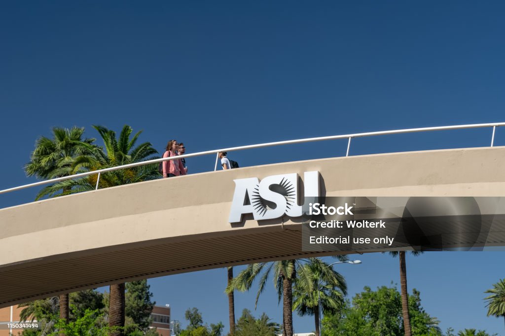 Unidentified Individuals Passing Overhead Bridge at Arizona State University TEMPE, AZ/USA - APRIL 10, 2019: Unidentified individuals passing overhead bridge on the campus of Arizona State University. Arizona State University Stock Photo