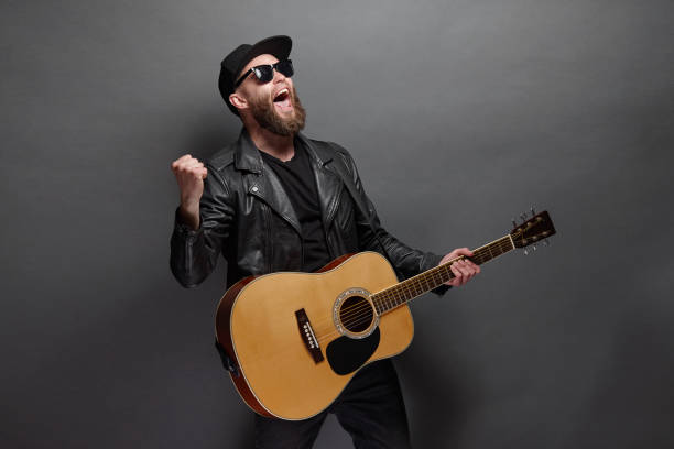 istock Guitar player with beard and black clothes 1150343173