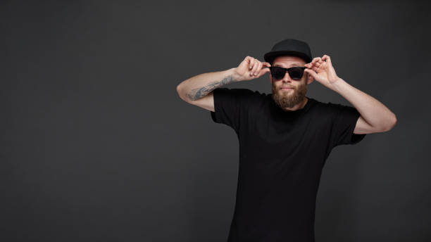 istock Hipster handsome male model with beard wearing black blank baseball cap with space for your logo 1150343570