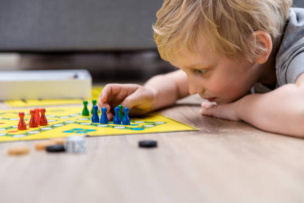 istock Little boy playing board game at home 1150343642