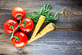 Top view of different types of vegetables on wood background.