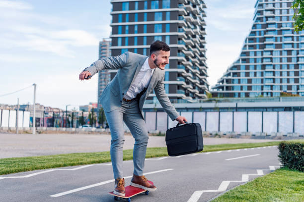 istock Stylish manager riding a skateboard in city 1150344810
