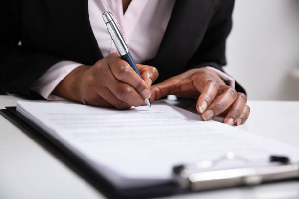 istock Woman Hands Writing On Clipboard With Pen 1150345112