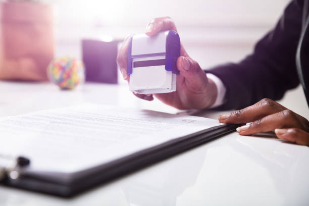 istock Businesswoman Putting Stamp On Documents 1150345144