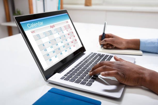 istock Businesswoman Writing Schedule In Calendar Diary 1150345206
