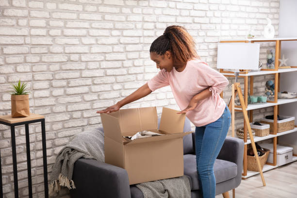 istock Woman Opening The Parcel Box 1150345571