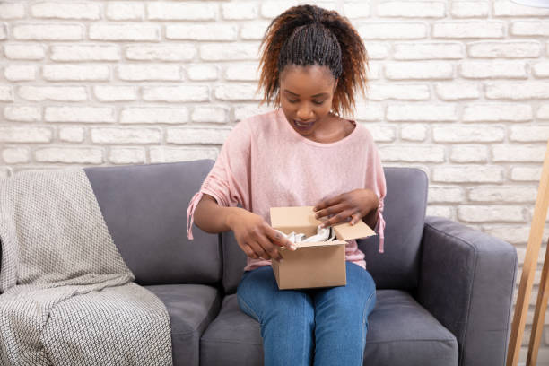 istock Woman Opening The Parcel Box 1150345578