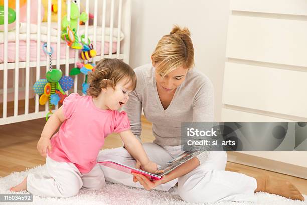 A Mother Reading A Story Book To Her Baby Girl Stock Photo - Download Image Now - Photo Album, Photography, Toddler