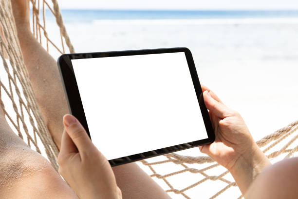 istock Woman Lying On Hammock Holding Digital Tablet 1150346282