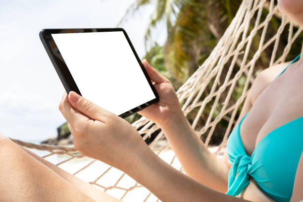 istock Woman Lying On Hammock Holding Digital Tablet 1150346303
