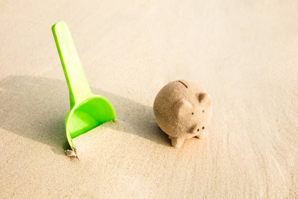 istock Plastic Shovel And Piggyback Made With Sand On Beach 1150346404