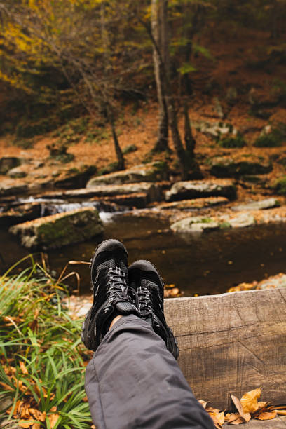 istock autumn leaves and human feet boots 1150347023