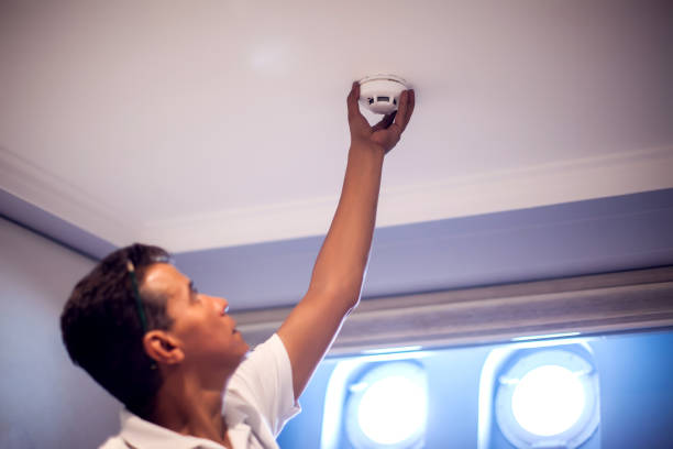 istock A man worker fix fire system on the ceiling. Building, renovation and electricity concept 1150348049